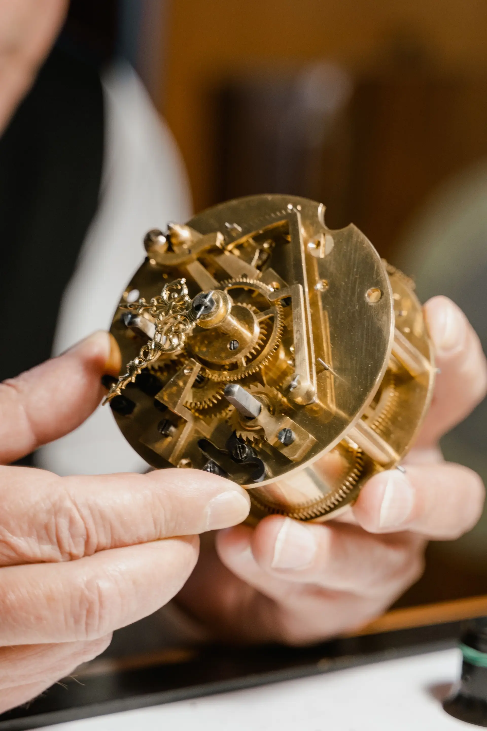 Clock movement being examined by hand