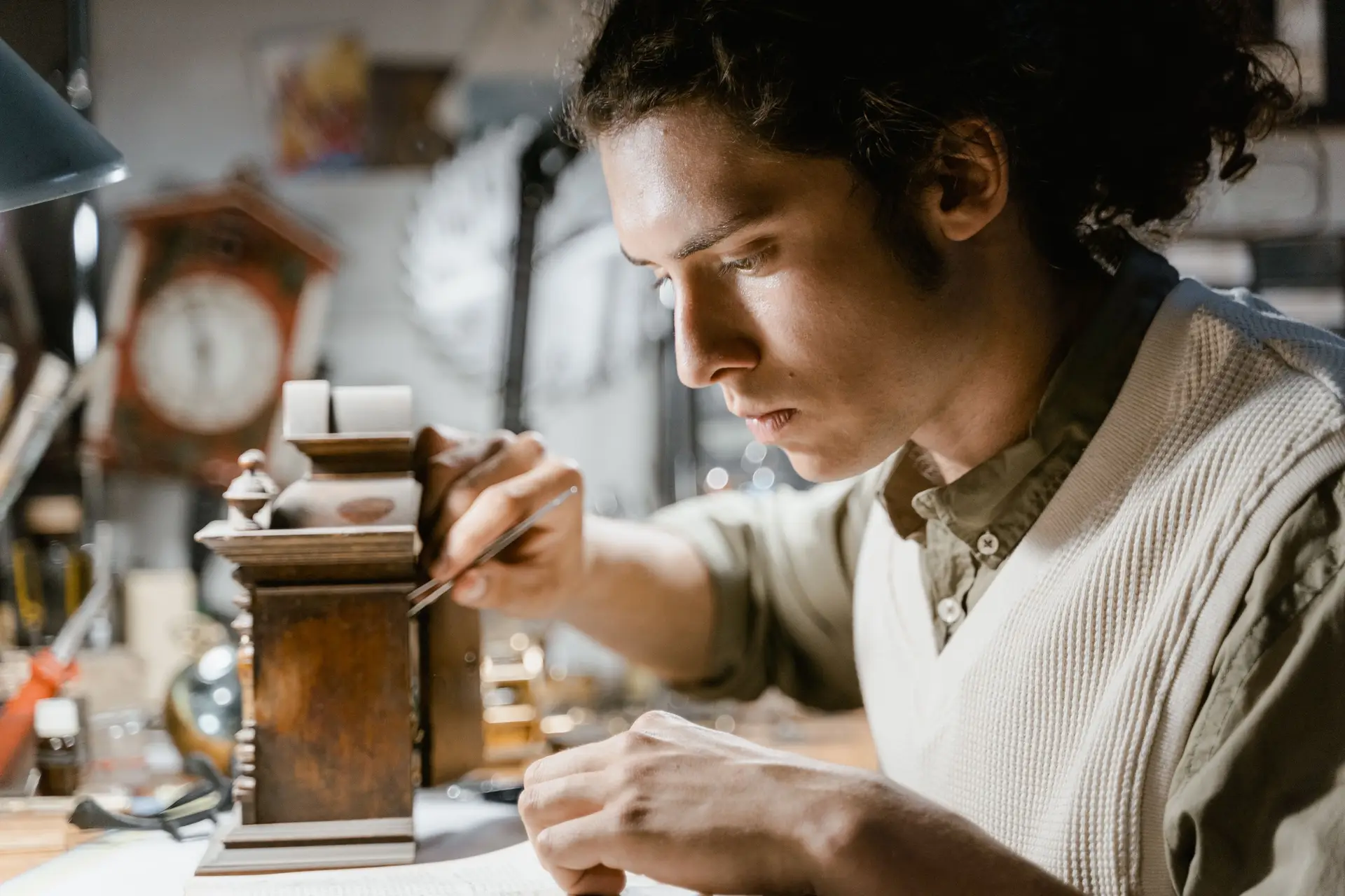 Horologist carefully working on a clock mechanism