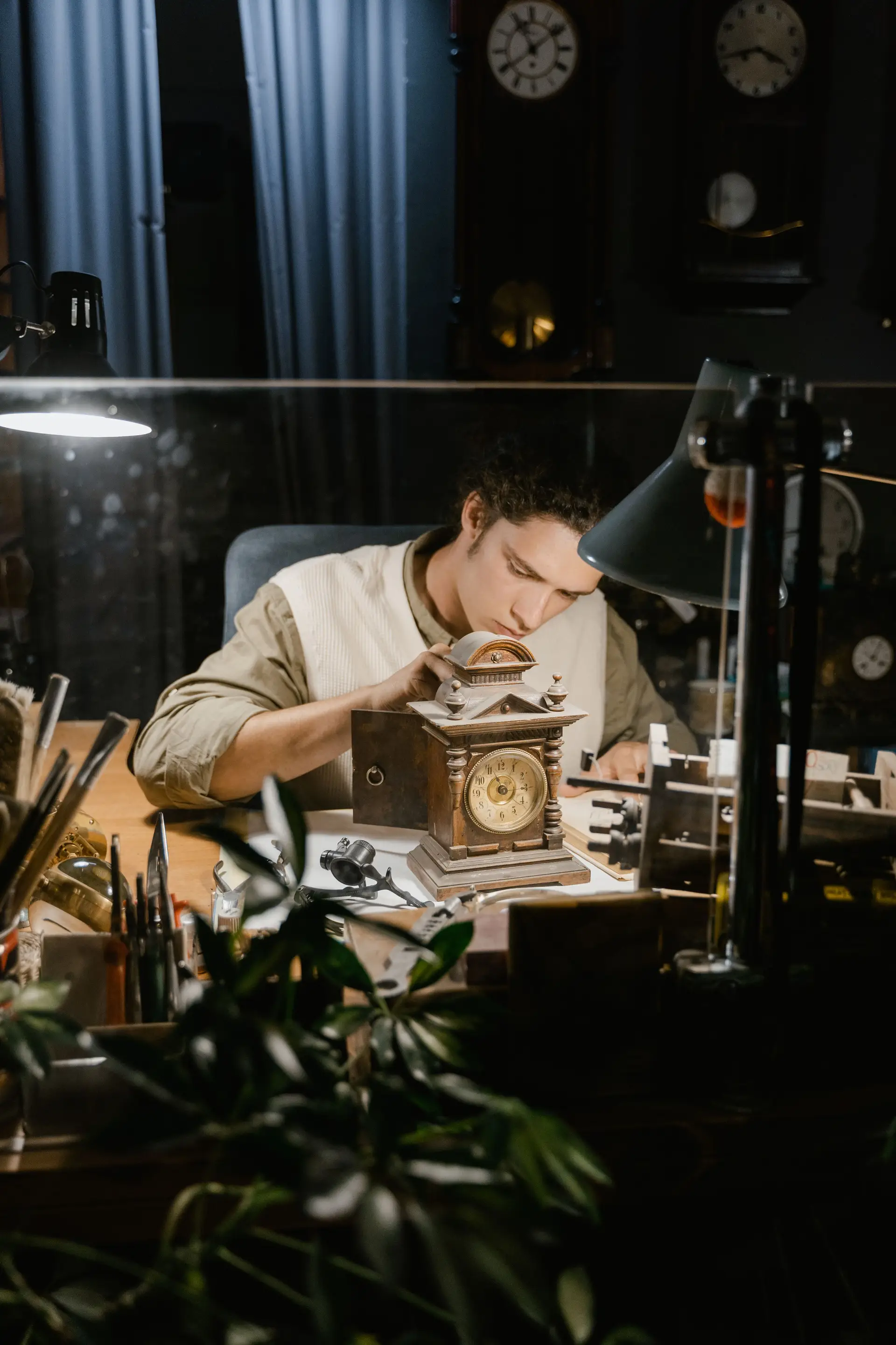 Watchmaker working carefully at a dark traditional bench