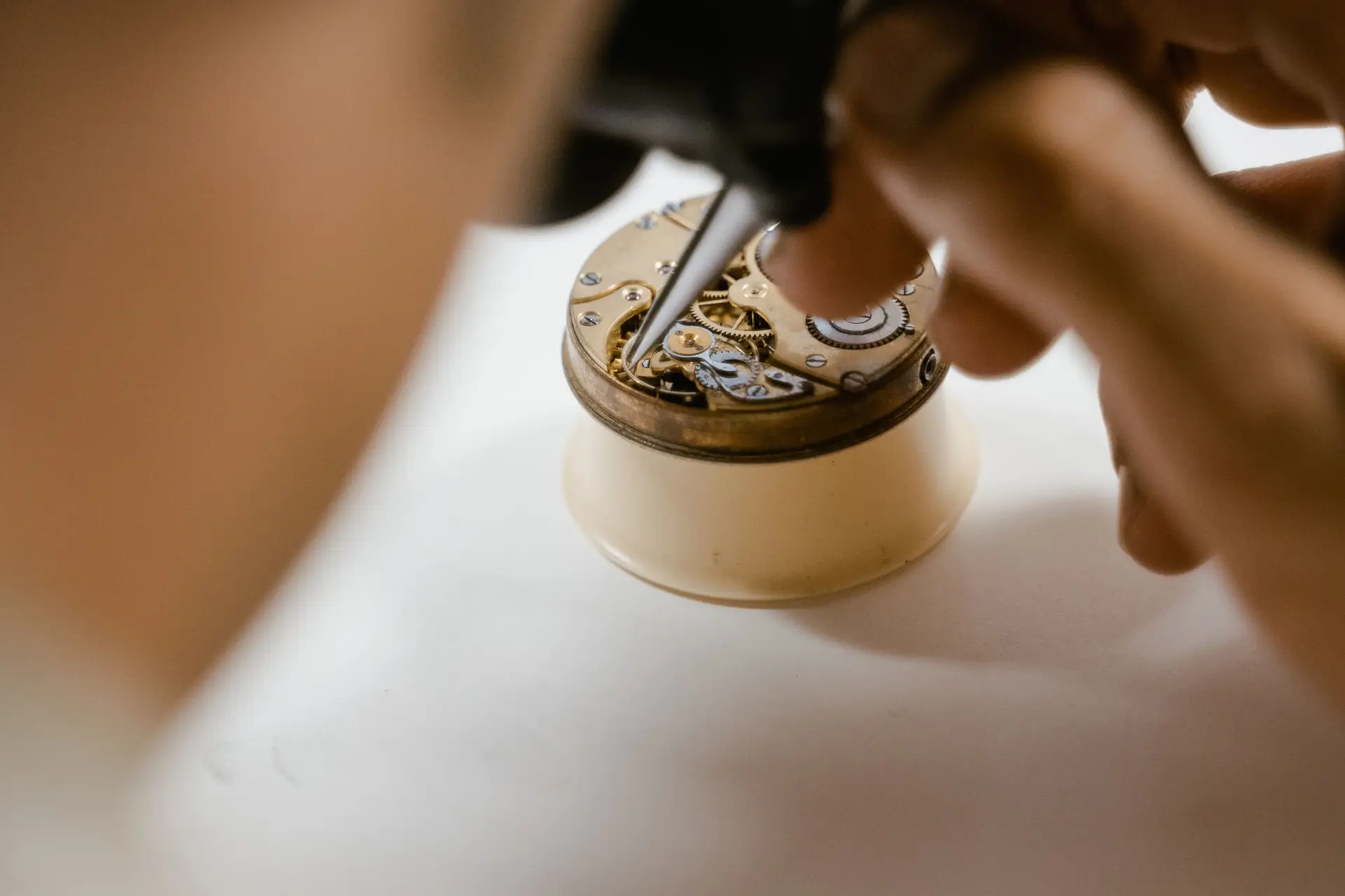 Close inspection of a watch movement on a bench