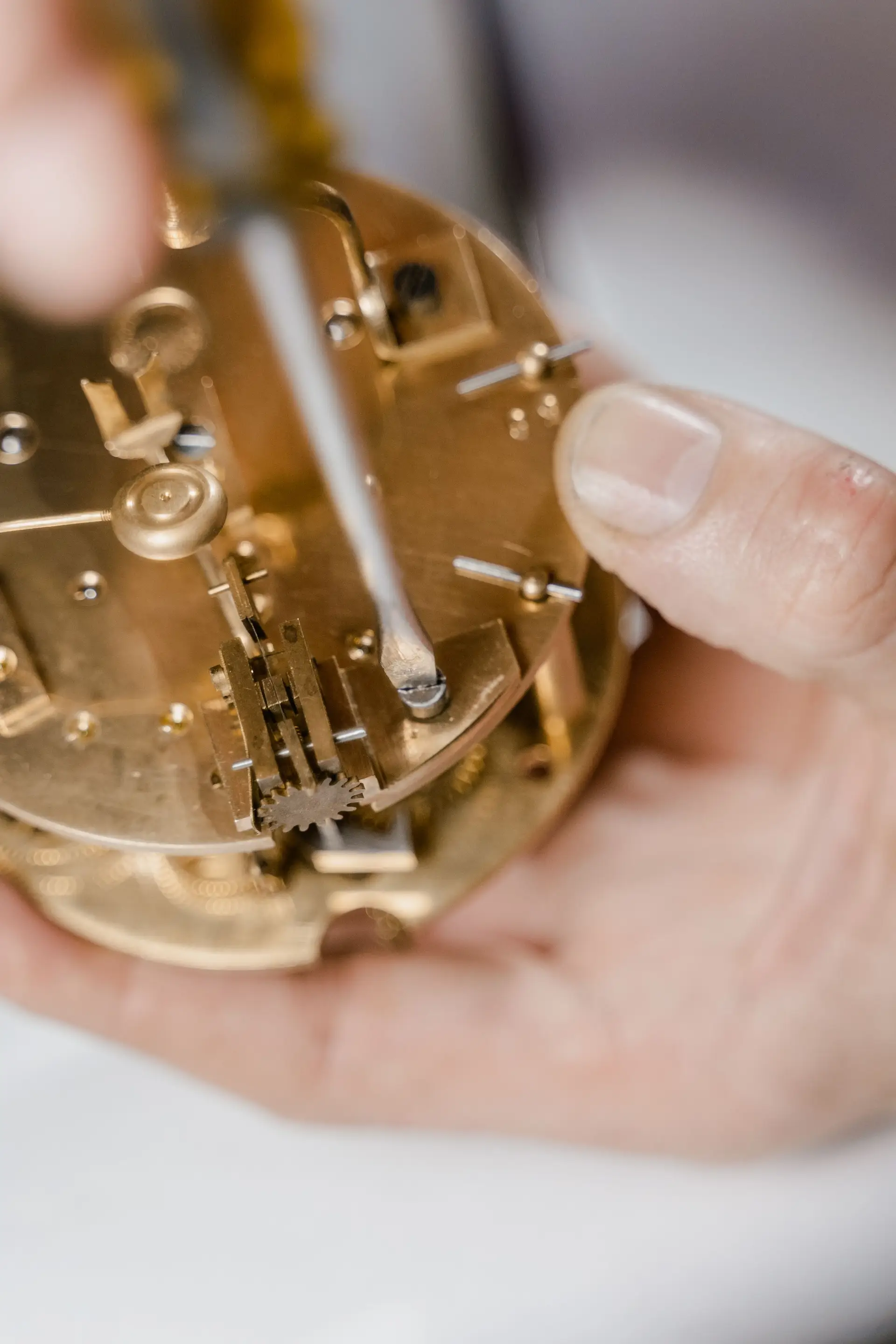 Clock movement held for close inspection